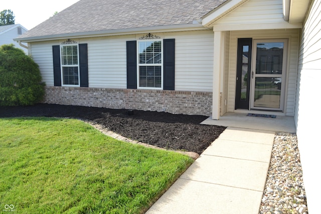 112 Marble Arch Way, Lafayette, IN 47905 - entrance to property featuring roof with shingles, a lawn, and brick siding