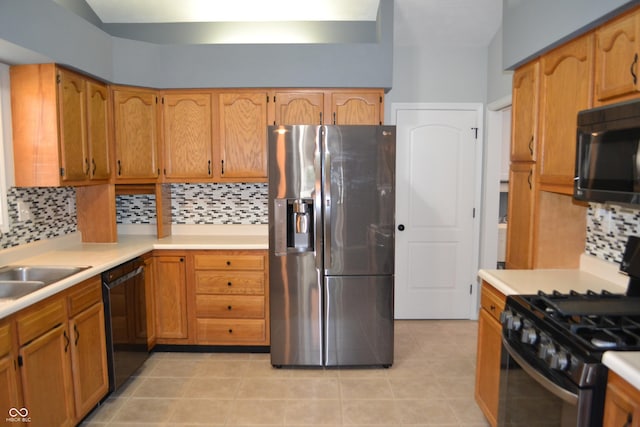 112 Marble Arch Way, Lafayette, IN 47905 - kitchen with black appliances, backsplash, light countertops, light tile patterned floors, and brown cabinetry