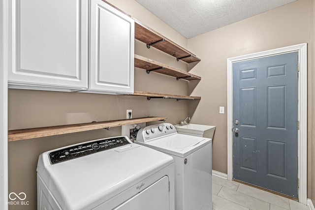 2920 Bloomsbury S, Greenwood, IN 46143 - laundry room featuring washer and dryer, cabinet space, a textured ceiling, and light tile patterned floors