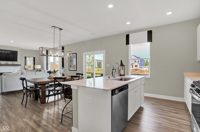 19838 Moorpark Lndg, Noblesville, IN 46062 - kitchen with stainless steel appliances, open floor plan, dark wood-style floors, a center island with sink, and light countertops