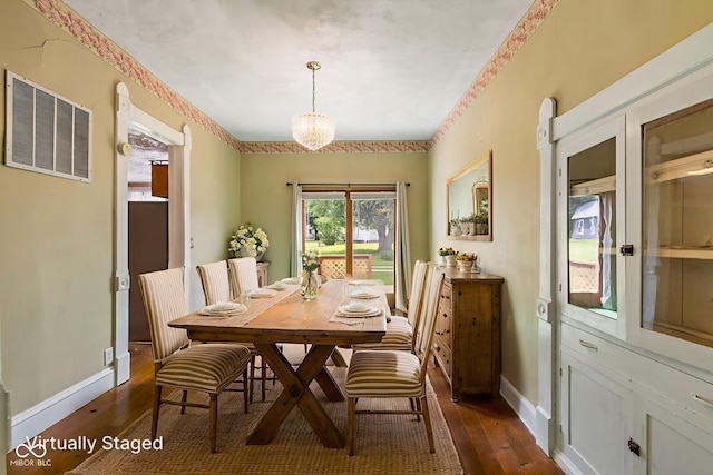 206 E Franklin St, Roachdale, IN 46172 - dining space with dark wood-style floors and a chandelier