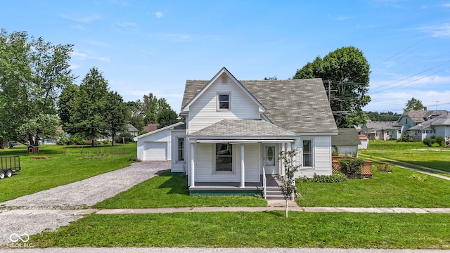 206 E Franklin St, Roachdale, IN 46172 - view of front of property featuring covered porch, a front lawn, a shingled roof, a chimney, and a detached garage