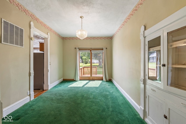 206 E Franklin St, Roachdale, IN 46172 - empty room featuring light colored carpet, a chandelier, and a textured ceiling