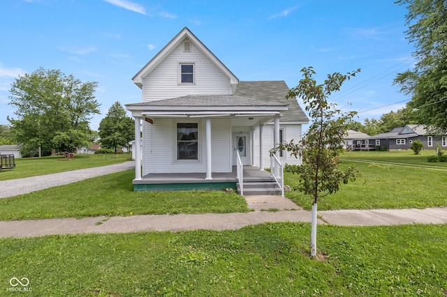 206 E Franklin St, Roachdale, IN 46172 - shotgun-style home featuring a porch, a front lawn, and a shingled roof