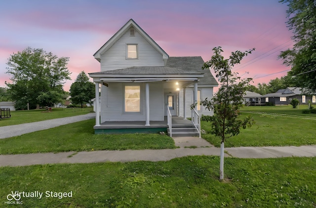 206 E Franklin St, Roachdale, IN 46172 - view of front facade with covered porch, a front lawn, and a shingled roof