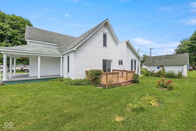206 E Franklin St, Roachdale, IN 46172 - rear view of property featuring a lawn, a shingled roof, a porch, and a wooden deck
