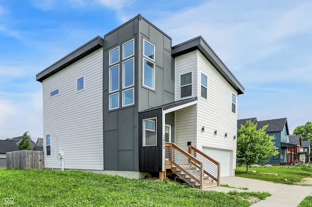 2008 Yandes St, Indianapolis, IN 46202 - view of front of home with a garage, driveway, and board and batten siding