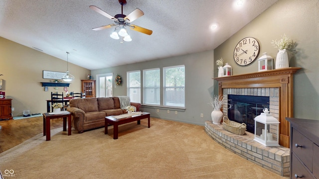 6816 Minnow Dr, Indianapolis, IN 46237 - living room with lofted ceiling, a ceiling fan, light colored carpet, a textured ceiling, and a brick fireplace
