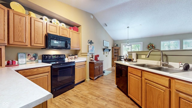 6816 Minnow Dr, Indianapolis, IN 46237 - kitchen with black appliances, vaulted ceiling, light wood finished floors, light countertops, and pendant lighting