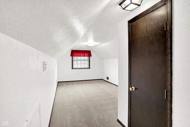 4070 Serenity Way Ct, Greenwood, IN 46142 - bonus room featuring light carpet, a textured ceiling, and lofted ceiling