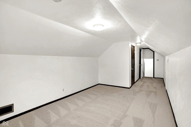 4070 Serenity Way Ct, Greenwood, IN 46142 - additional living space featuring light carpet, lofted ceiling, and a textured ceiling