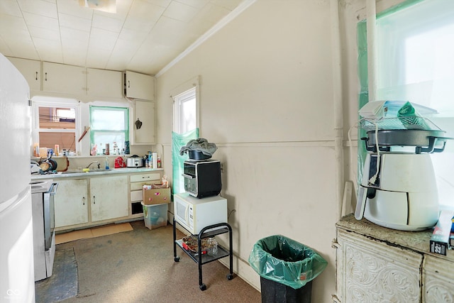 315 N High St, Hartford City, IN 47348 - kitchen featuring stove, light countertops, and freestanding refrigerator