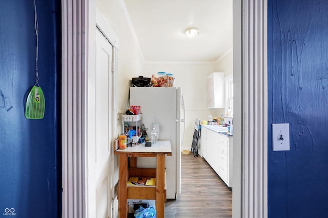315 N High St, Hartford City, IN 47348 - kitchen featuring freestanding refrigerator, ornamental molding, wood finished floors, light countertops, and white cabinets