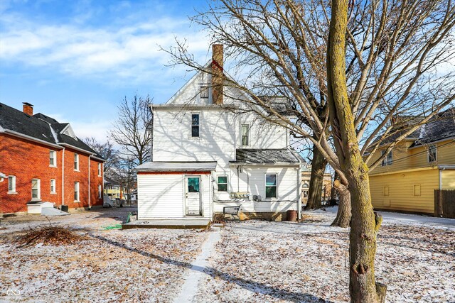 315 N High St, Hartford City, IN 47348 - snow covered back of property featuring a chimney and a deck