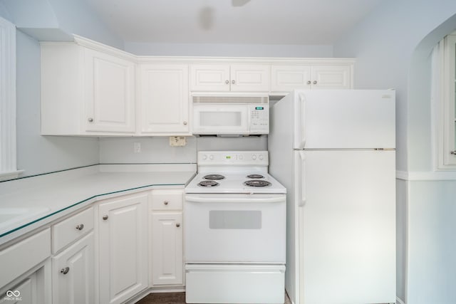 171 Nursery Rd, Anderson, IN 46012 - kitchen featuring white appliances, arched walkways, white cabinetry, and light countertops