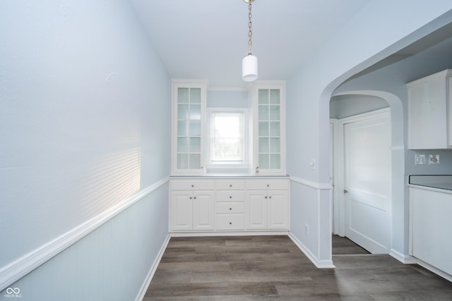 171 Nursery Rd, Anderson, IN 46012 - unfurnished dining area featuring arched walkways and dark wood finished floors