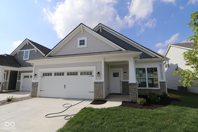 10604 Maidenhair Dr, Indianapolis, IN 46239 - craftsman inspired home featuring driveway, an attached garage, stone siding, a front lawn, and roof with shingles