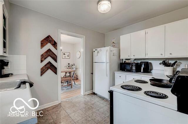 5363 Primrose Ave, Indianapolis, IN 46220 - kitchen featuring white appliances, white cabinetry, and light countertops
