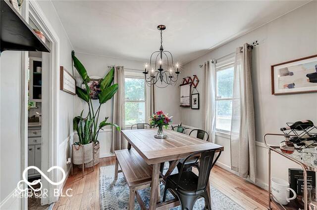 5363 Primrose Ave, Indianapolis, IN 46220 - dining room featuring a chandelier, healthy amount of natural light, and light wood-style floors