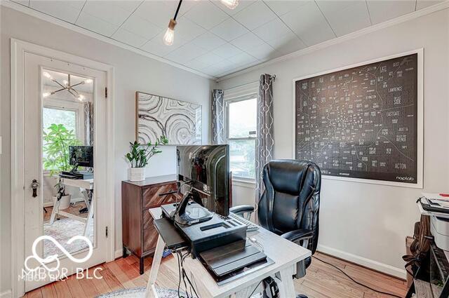 5363 Primrose Ave, Indianapolis, IN 46220 - office area with ornamental molding, wood finished floors, healthy amount of natural light, and a chandelier