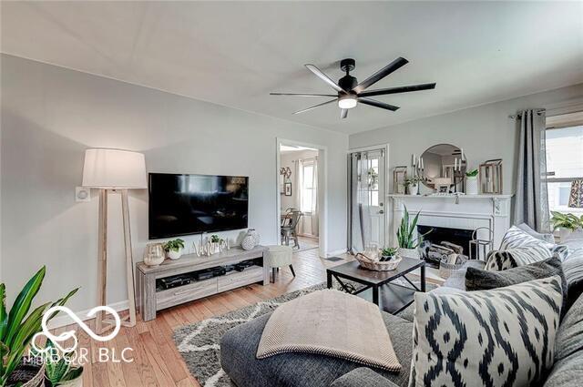 5363 Primrose Ave, Indianapolis, IN 46220 - living area featuring ceiling fan, light wood-style floors, and a fireplace