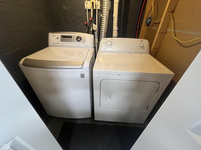 5363 Primrose Ave, Indianapolis, IN 46220 - laundry room featuring separate washer and dryer and concrete block wall