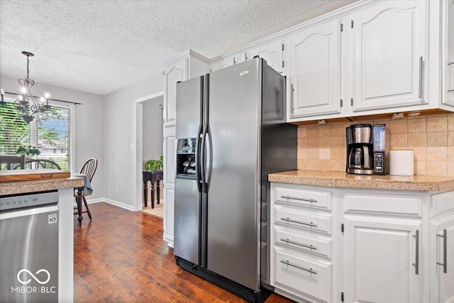 770 Viewpoint Dr, Plainfield, IN 46168 - kitchen featuring appliances with stainless steel finishes, a chandelier, dark wood-style floors, white cabinets, and a textured ceiling