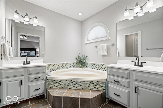770 Viewpoint Dr, Plainfield, IN 46168 - ensuite bathroom featuring two vanities, a bath, and tile patterned flooring