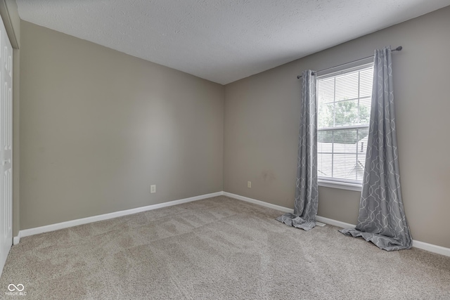 7914 Willow Wind Cir, Indianapolis, IN 46239 - carpeted spare room featuring baseboards and a textured ceiling
