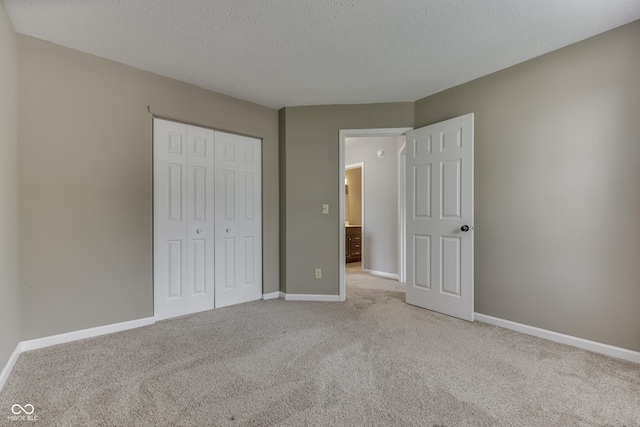 7914 Willow Wind Cir, Indianapolis, IN 46239 - unfurnished bedroom featuring light colored carpet, a closet, and a textured ceiling