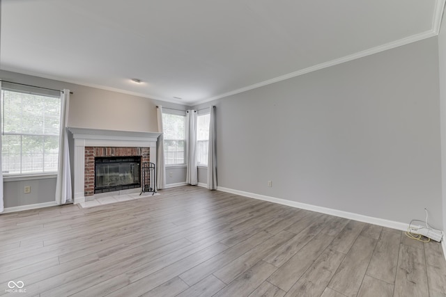 7914 Willow Wind Cir, Indianapolis, IN 46239 - unfurnished living room with light wood finished floors, ornamental molding, and a fireplace