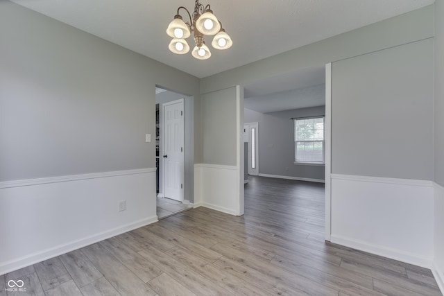 7914 Willow Wind Cir, Indianapolis, IN 46239 - unfurnished room featuring a chandelier and wood finished floors