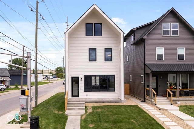 1100 English Ave, Indianapolis, IN 46203 - rear view of house featuring a porch and a yard