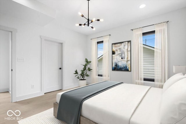 1100 English Ave, Indianapolis, IN 46203 - bedroom featuring multiple windows, a chandelier, light wood finished floors, and recessed lighting
