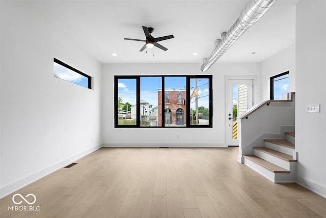 1100 English Ave, Indianapolis, IN 46203 - spare room featuring a ceiling fan, wood finished floors, stairs, and recessed lighting