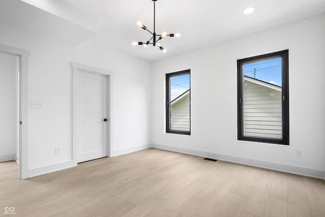1100 English Ave, Indianapolis, IN 46203 - spare room featuring a chandelier, healthy amount of natural light, light wood-type flooring, and recessed lighting