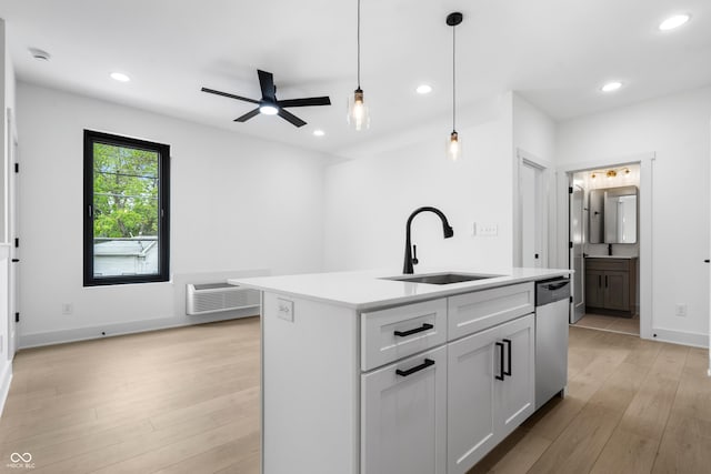 1100 English Ave, Indianapolis, IN 46203 - kitchen featuring dishwasher, light wood-style floors, a ceiling fan, light countertops, and decorative light fixtures