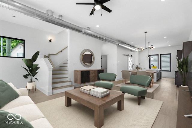 1100 English Ave, Indianapolis, IN 46203 - living room featuring recessed lighting, a ceiling fan, stairs, light wood-style floors, and plenty of natural light