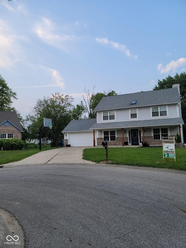 922 Eagle Brook Dr, Shelbyville, IN 46176 - view of front of house featuring concrete driveway, a front yard, covered porch, and an attached garage