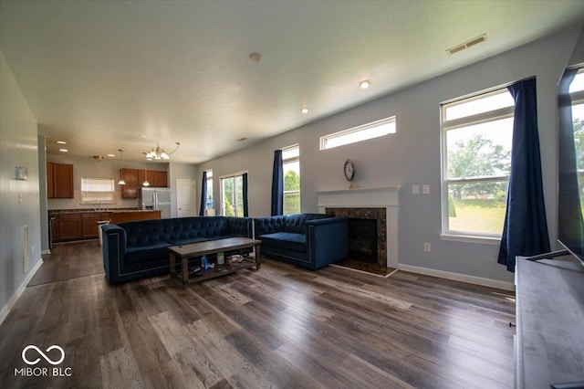 5859 Edelle Dr, Indianapolis, IN 46237 - living area featuring a fireplace, dark wood-style flooring, a chandelier, and recessed lighting