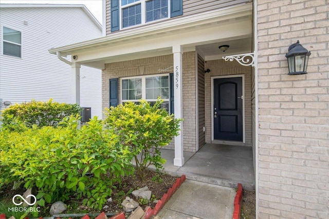 5859 Edelle Dr, Indianapolis, IN 46237 - doorway to property with brick siding and covered porch