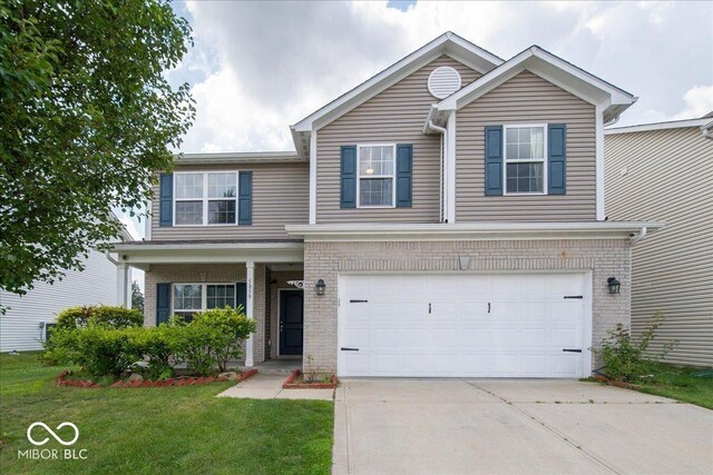 5859 Edelle Dr, Indianapolis, IN 46237 - traditional-style home featuring concrete driveway, a garage, a front yard, and brick siding