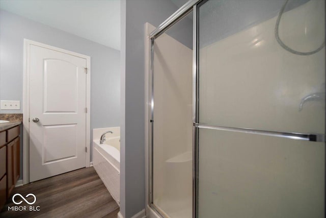 5859 Edelle Dr, Indianapolis, IN 46237 - full bathroom with wood finished floors, a stall shower, vanity, and a bath