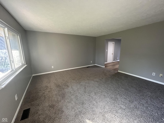 3525 Valley Lake Dr, Indianapolis, IN 46227 - spare room with baseboards and dark carpet