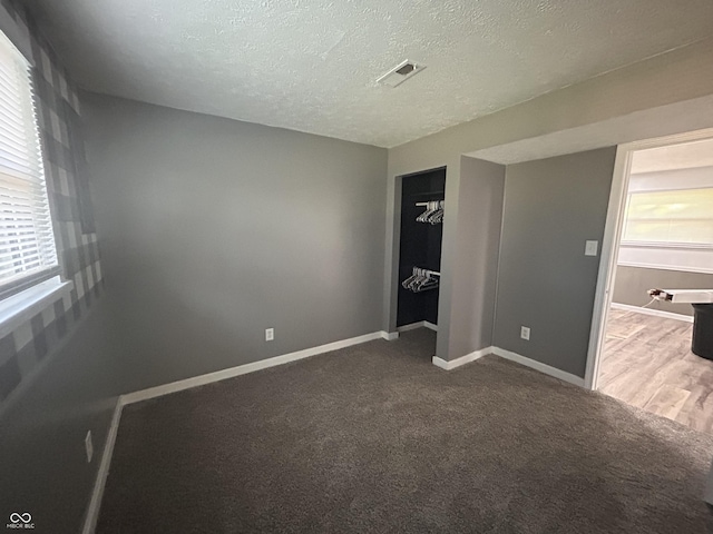 3525 Valley Lake Dr, Indianapolis, IN 46227 - unfurnished bedroom featuring a textured ceiling, a closet, and carpet floors