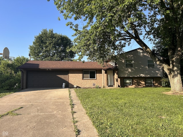 3525 Valley Lake Dr, Indianapolis, IN 46227 - tri-level home with a garage, concrete driveway, and a front lawn