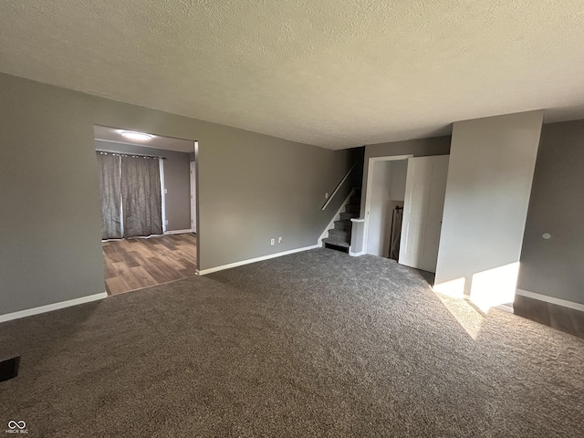 3525 Valley Lake Dr, Indianapolis, IN 46227 - unfurnished room featuring carpet flooring, stairway, and a textured ceiling