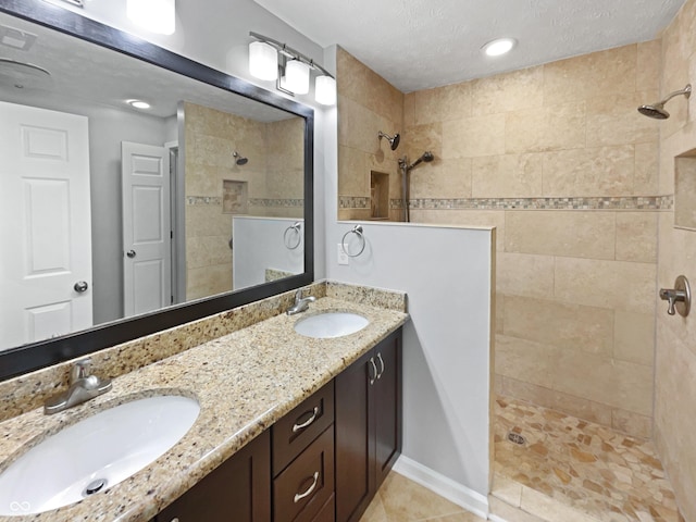770 Tulip Ln, Greenwood, IN 46143 - full bathroom with walk in shower, double vanity, tile patterned floors, and a textured ceiling