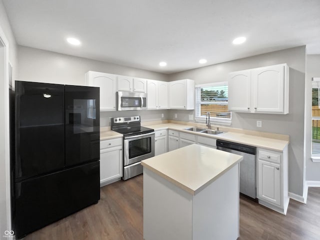 770 Tulip Ln, Greenwood, IN 46143 - kitchen featuring appliances with stainless steel finishes, dark wood finished floors, white cabinets, light countertops, and recessed lighting