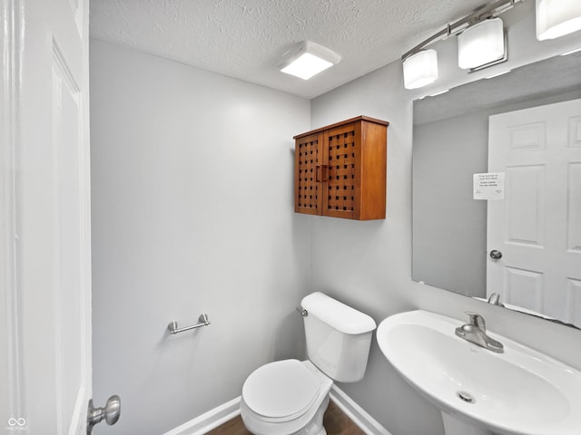 770 Tulip Ln, Greenwood, IN 46143 - half bathroom featuring a sink and a textured ceiling